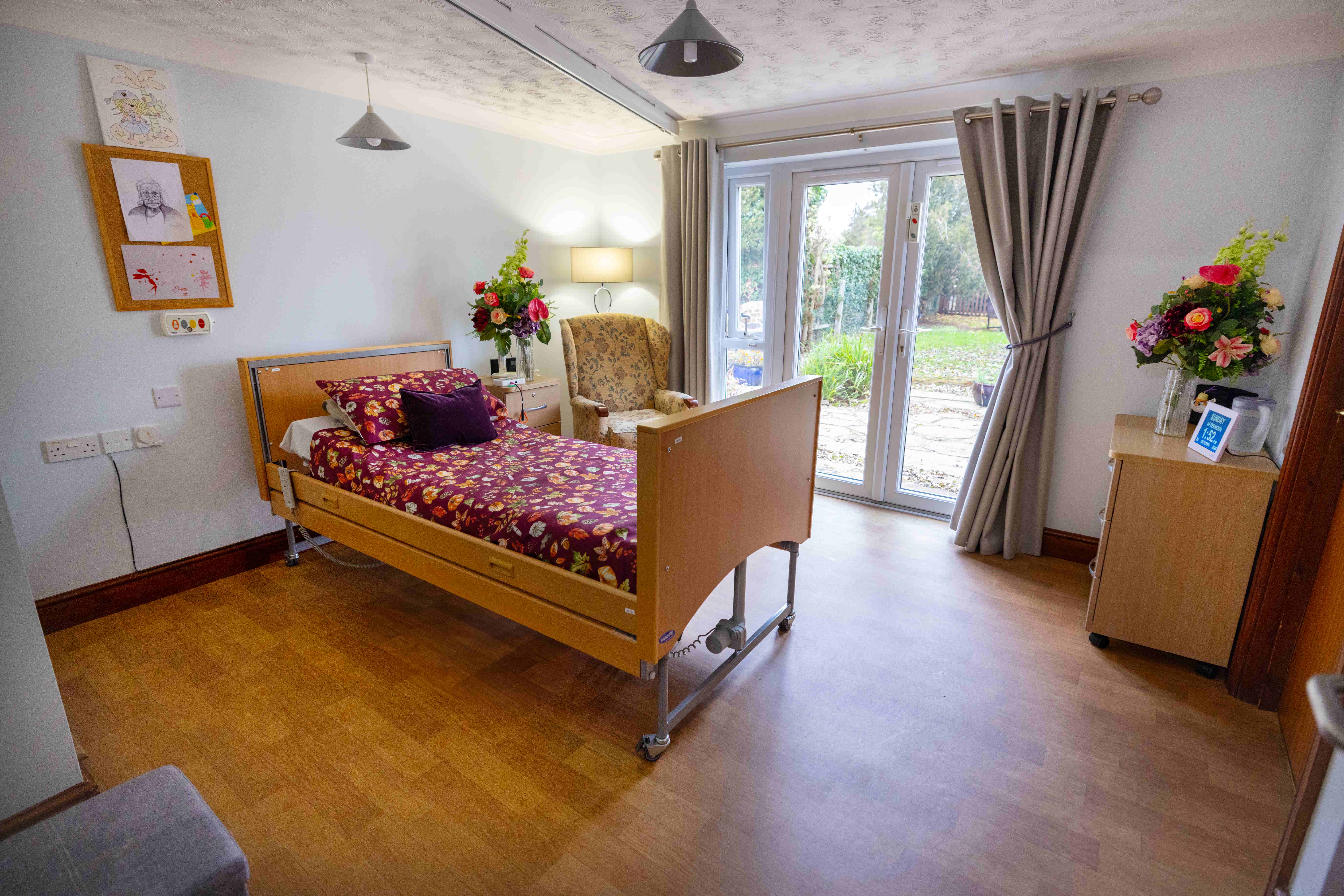 Private resident bedroom with direct garden access and adjustable bed